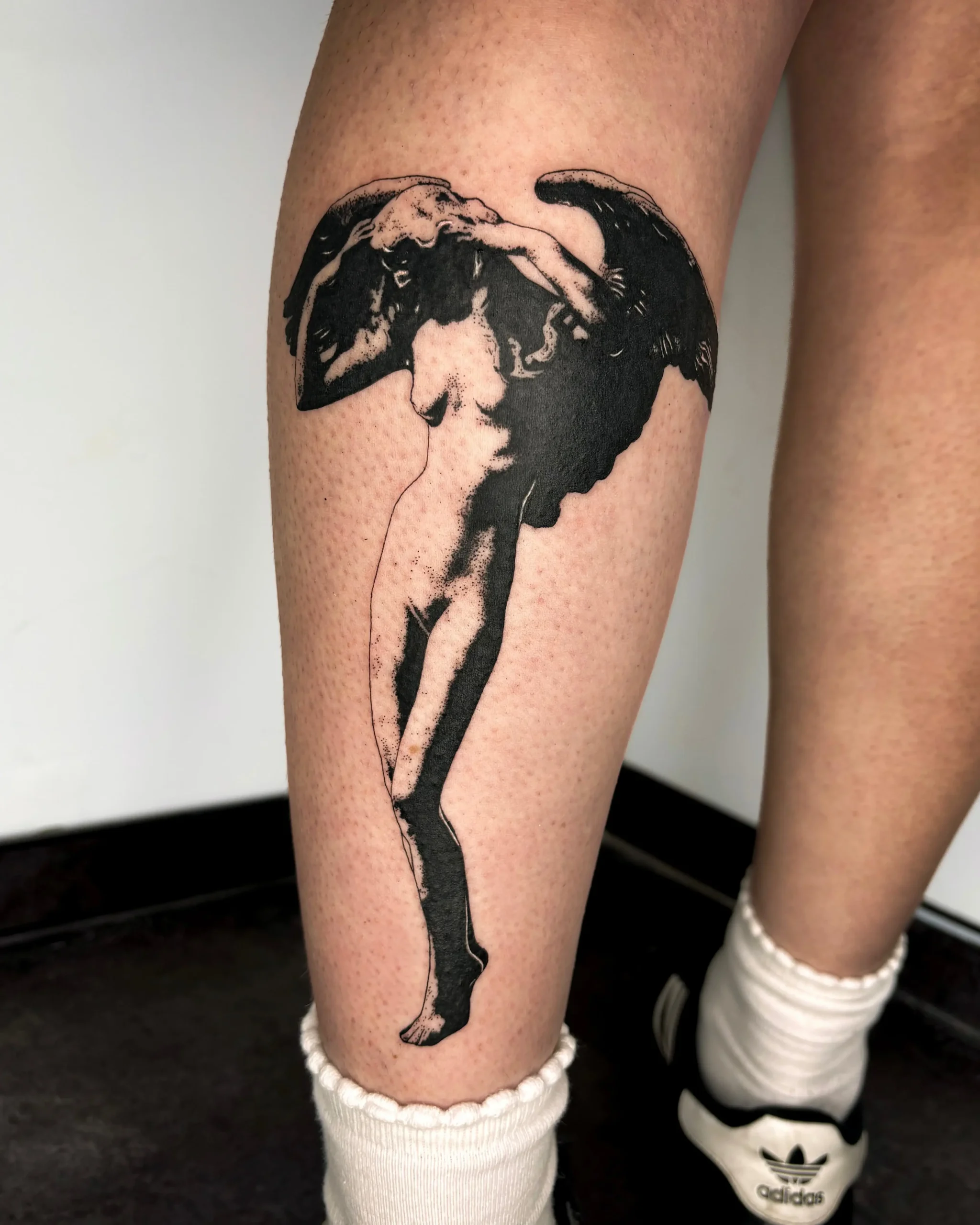 High-contrast Led Zeppelin Icarus tattoo with bold black shading on leg - Walk In Tattoo Budapest
