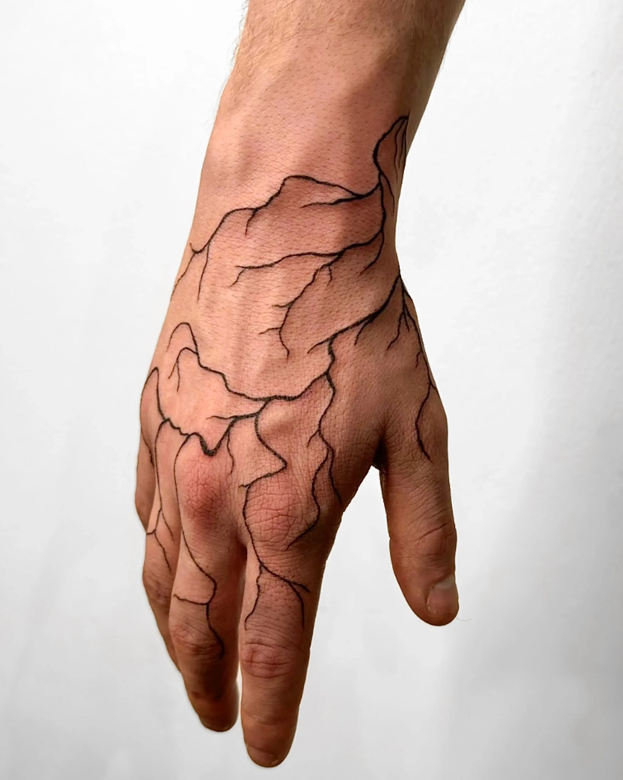 Abstract organic blackwork hand tattoo with vein-like flowy lines - Walk In Tattoo Budapest
