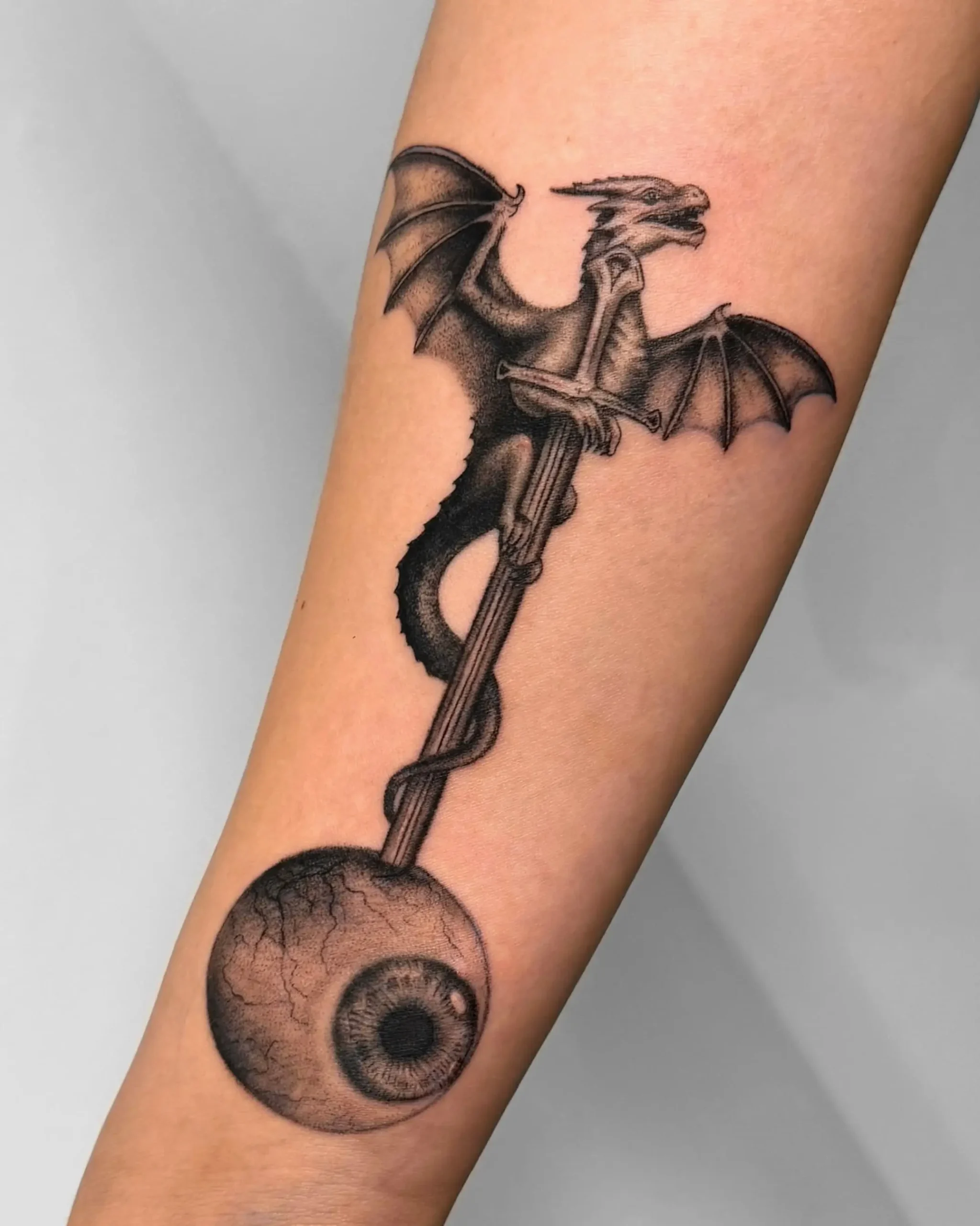 Detailed dark art dragon tattoo clutching a realistic eye - Walk In Tattoo Budapest Detailed dark art dragon tattoo clutching a realistic eye - Walk In Tattoo Budapest